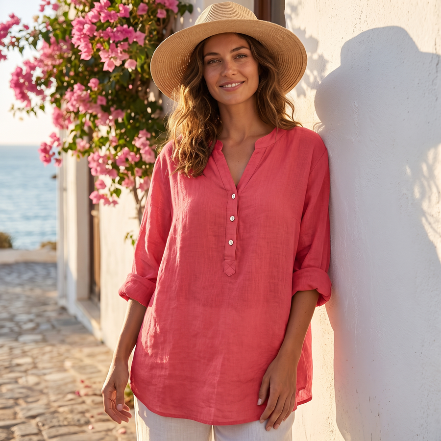 Veronique cotton-linen blouse in watermelon pink, worn on a sunny Mediterranean street