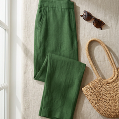 Clementine trousers in green styled flat-lay with straw bag and sunglasses