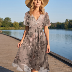 Woman wearing the Lavina Vibrant Boho Midi Dress on a waterfront boardwalk