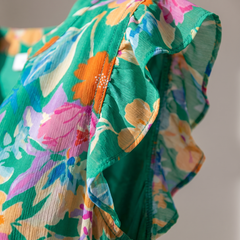 Lila floral tiered midi dress close-up detail of V-neckline and flutter sleeve