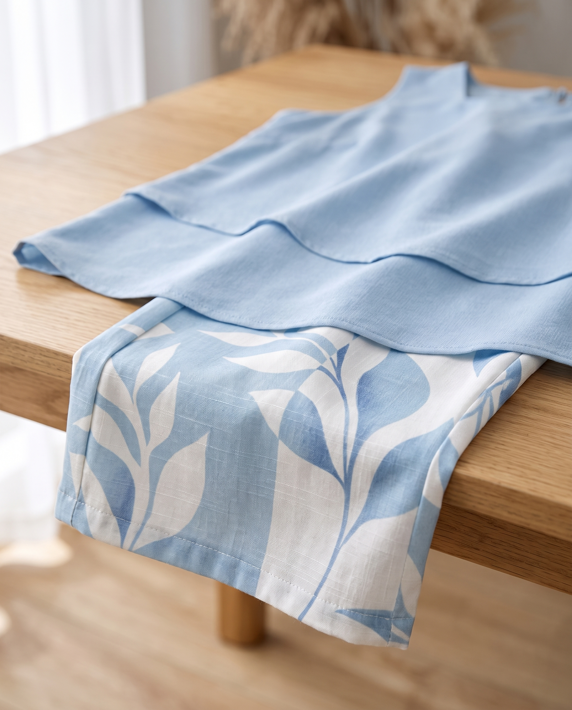 Close-up of the botanical print fabric and layered top of the Sky Blossom Set