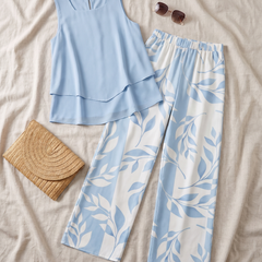 Flat-lay of the Aurelyssa Sky Blossom Set two-piece with straw bag and sunglasses