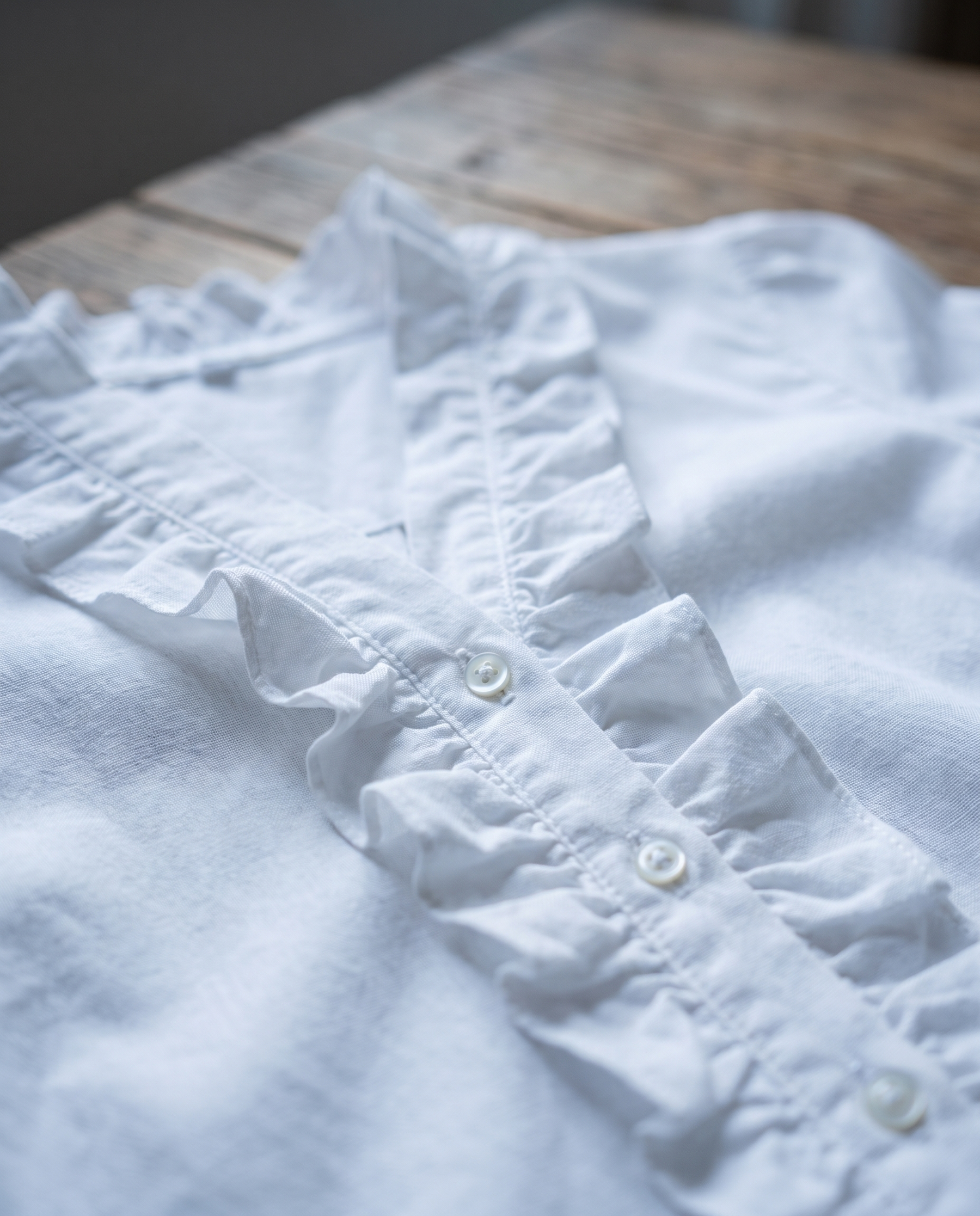 Isadora blouse ruffle and button detail close-up