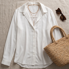 Natalie Elegant Blouse styled flat-lay with straw bag and sunglasses