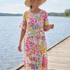 Elena floral midi dress worn on a coastal walkway