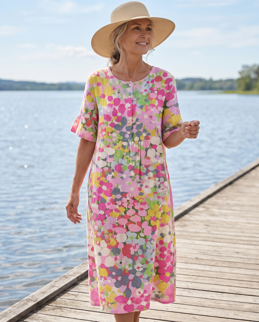Elena floral midi dress worn on a coastal walkway