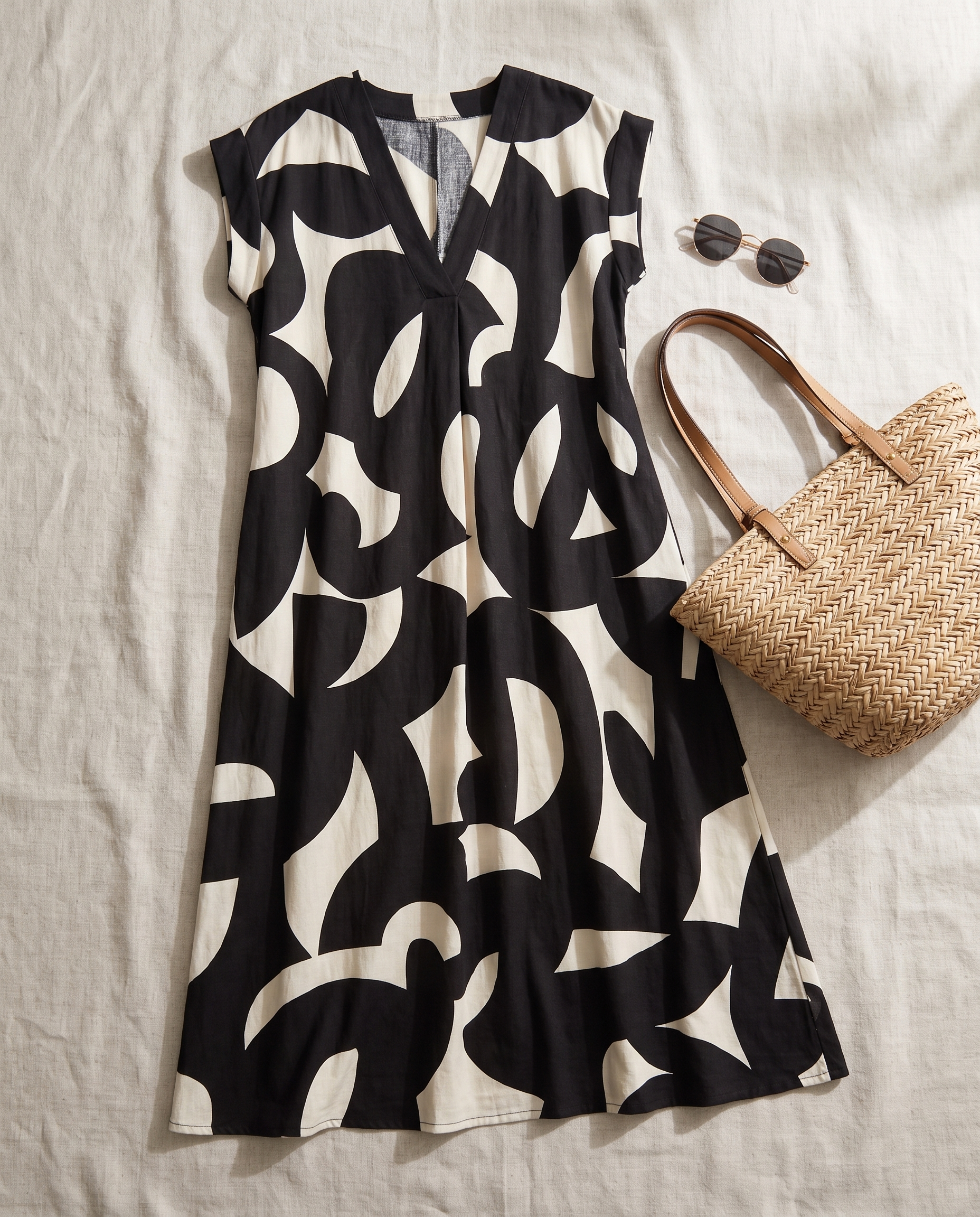 Ella Bold Print Maxi Dress styled flat-lay with straw tote and sunglasses